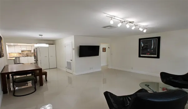 Spacious with natural lighting, impact windows, TV attached to the wall.