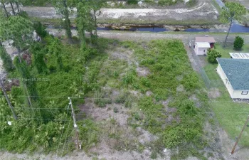 Nestled in a serene setting, this 10,000 square feet piece of land offers a perfect blend of tranquility and potential. The back of the property features a picturesque canal, providing a soothing view and a natural habitat for local wildlife. The low, mulched grass enhances the landscape's charm, creating an inviting space ideal for outdoor activities or peaceful gatherings. This versatile land is perfect for building your dream home.