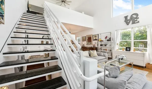Living room stairs leading to primary left bedroom on 3rd floor