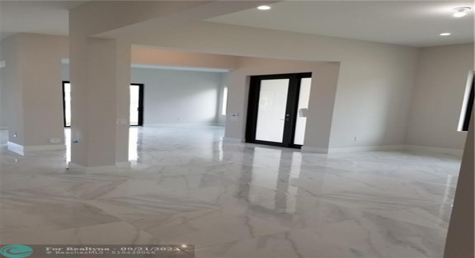 Living Room/Dining Room Foyer Area - Photo from previously built home -Porcelain flooring standard