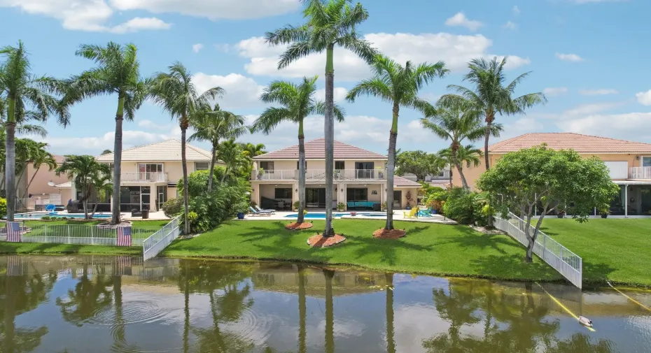 Oasis backyard overlooking a beautiful lake. This home is one of the few that has a balcony running the full length of the back of the house.