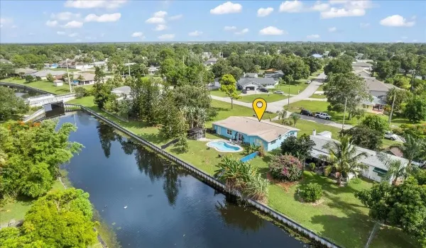 Ariel shot of the pool home with views of the canal