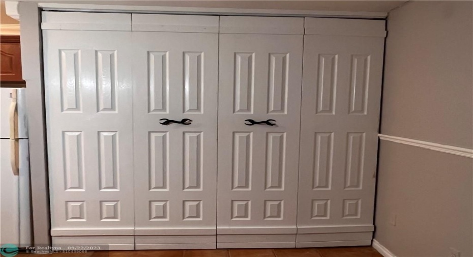 Closet with queen size bed inside