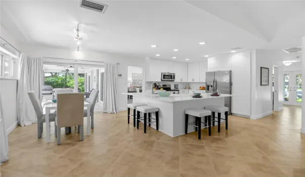 Updated kitchen highlights stainless steel appliances, large panty and farmhouse sink. Big center island featuring marble counters.
