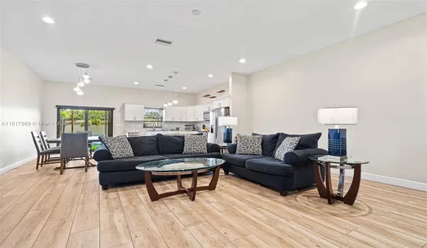 Very ample and bright living room.  There is enough space for another sofa.