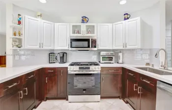 Featuring gorgeous gas range, match in stainless steel appliances, sleek countertops, and new cabinetry, and