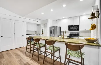 This coastal style home offers real hardwood floors, raised panel doors, recessed LED lighting and a quartzite countertop.