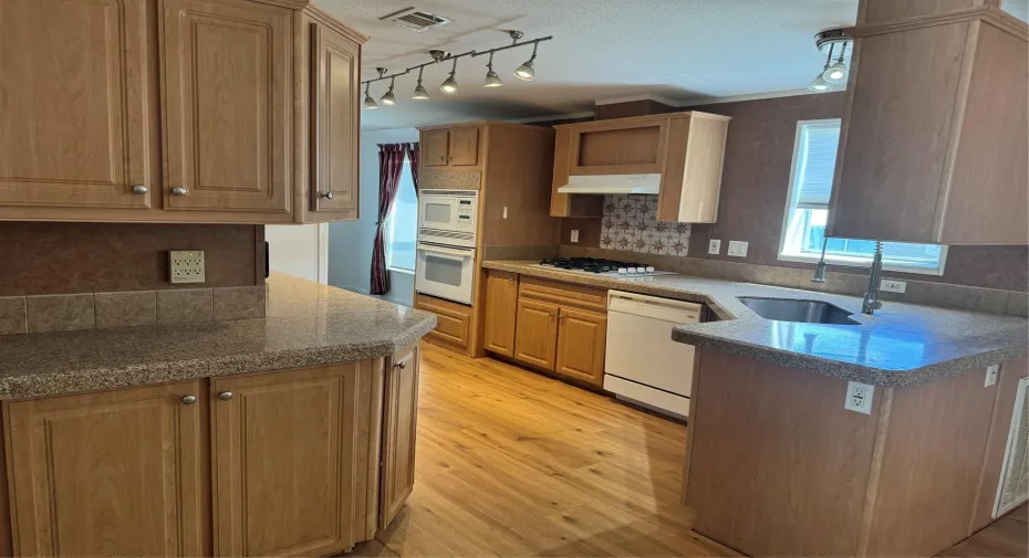 BEAUTIFULLY UPDATED KITCHEN WITH QUARTZ COUNTERTOPS.