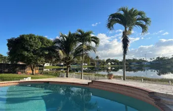 Private pool with covered patio, gated backyard & lake