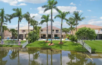 Oasis backyard overlooking a beautiful lake. This home is one of the few that has a balcony running the full length of the back of the house.