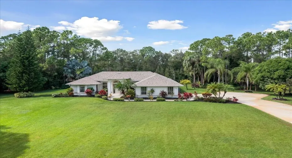 View of front of property with a front lawn and driveway