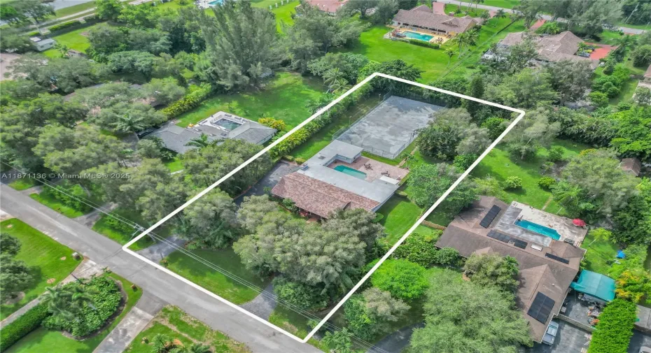 Beautiful property with large circular drive, lush landscape & a hard court