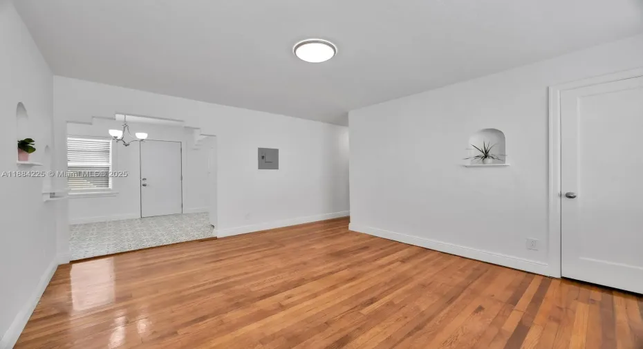 Miami's wonderful Coral Gables location. Very central in Miami. Updated kitchen that is beautiful. Tile floor in kitchen is wonderful.
Living area. Wonderful wood flooring. Plenty of light. Three window unit air conditioners.
