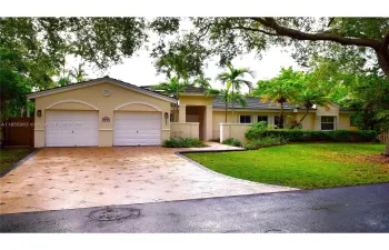 Street view of 10521 SW 75th Court, Palmetto Bay, Florida  33158.  West Exposure. Two Car Garage, Paver Driveway and Entry walk. Flat Tile Roof.