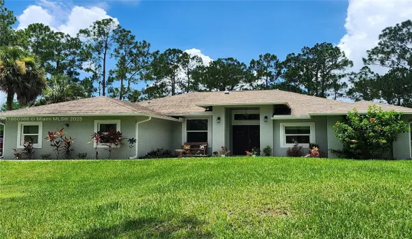 Ranch-style house with an expansive beautiful yard.