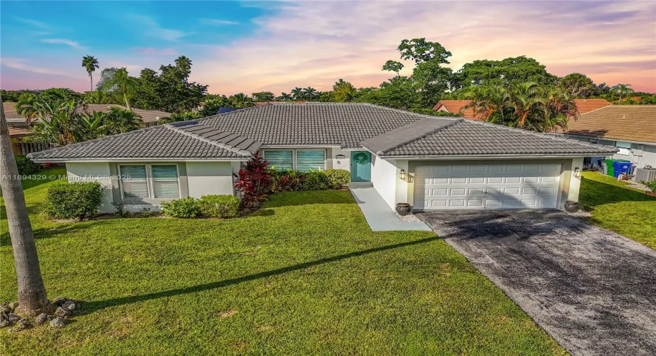 This lovely single-story home features a crisp white exterior, a 2024 tiled roof, and a large front yard that glows under the southern sun. Large windows and a green fron door fill the interior with natural light, while the two-car garage, paved driveway, and street parking provide plenty of parking space. With its south-facing orientation, the home stays bright and cozy year-round-perfect for energy savings and enjoying sunny outdoor living.