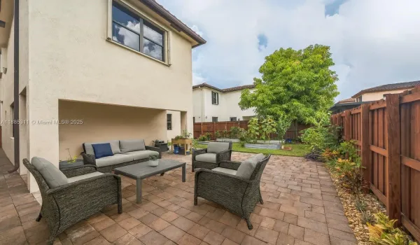 Outdoor patio with paver flooring, perfect for BBQs, alfresco dining, and relaxing under the Florida sun.