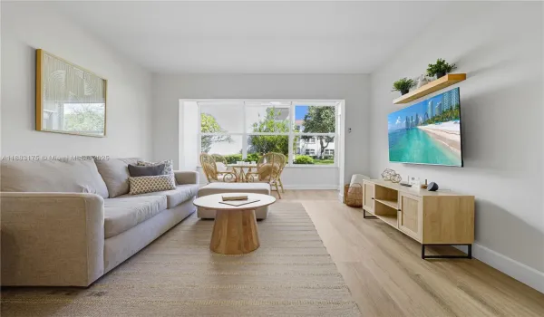 Open concept dining and living room area, connects to the enclosed patio.