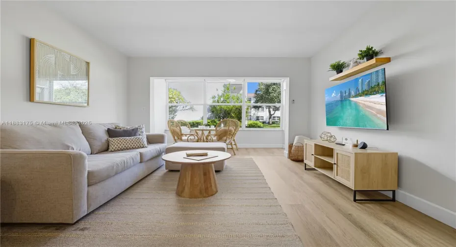 Open concept dining and living room area, connects to the enclosed patio.