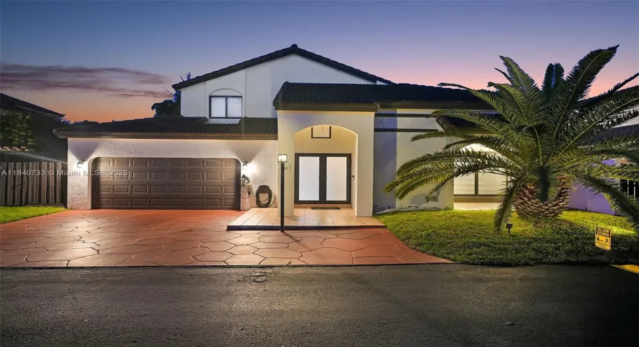 Twilight picture of Home with two-car garage