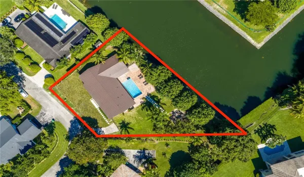 Set on an oversized 21,000 sq.ft. lot, this property offers a spectacular and rare view of the junction of two canals, making it truly one of a kind in Pinecrest.