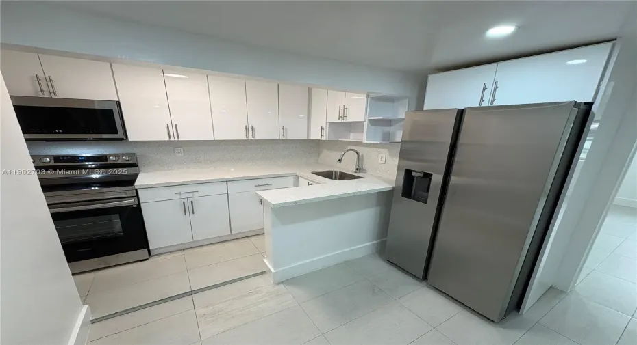 Remodeled kitchen w/ stainless steel appliances.