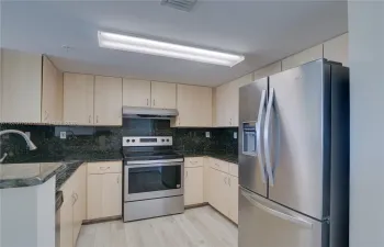 RENOVATED KITCHEN WITH GRANITE COUNTERTOPS, STAINLESS STEEL APPLIANCES AND NEW TOP-OF-THE-LINE CERAMIC FLOORS