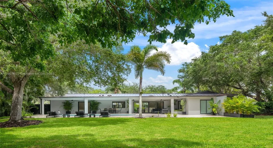 Fully rebuilt with exquisite taste, 5BR/4.5BA, rare 21,875sf lot, lush privacy, high-end finishes, covered terrace, pool, and 1-car garage.