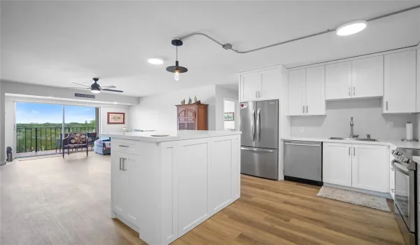 Open kitchen with quartz island with storage and upgraded appliances (2023)