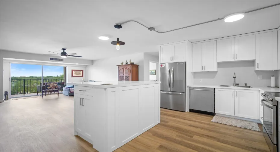 Open kitchen with quartz island with storage and upgraded appliances (2023)