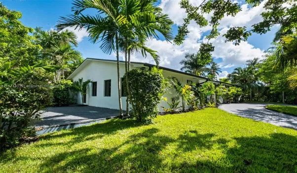 Charming modern home surrounded by palm trees and greenery