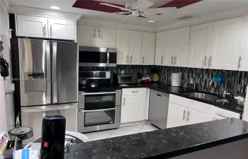 Renovated ample kitchen. Modern down lights