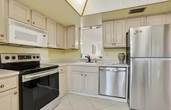 WOOD CABINETS, STAINLESS APPLS., ICEMAKER REFRIG.,  MICROWAVE, DISHWASHER STAINLESS INSIDE, SMOOTH TOP RANGE