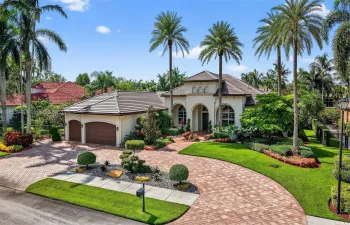 Large Paved circular driveway, lush landscaping, and a brand-new 2024 flat tile roof create stunning curb appeal.