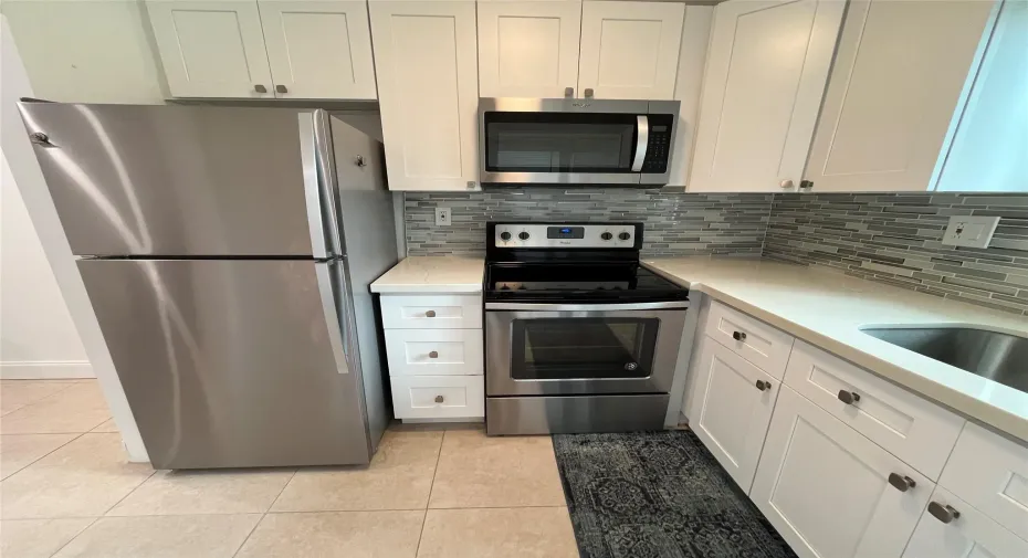 Updated kitchen with granite countertops and stainless steel appliances