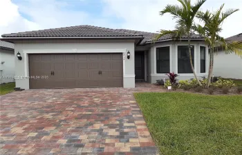 house with pretty paver driveway