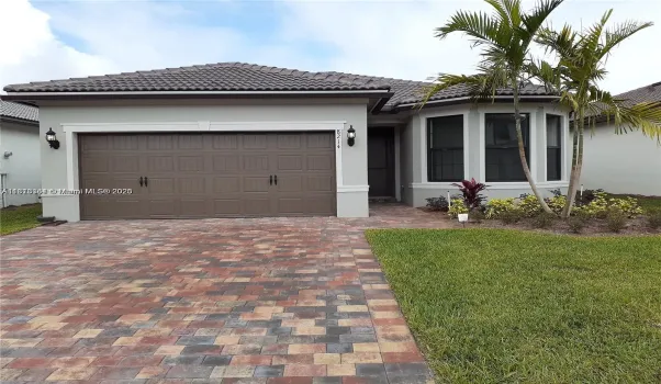 house with pretty paver driveway