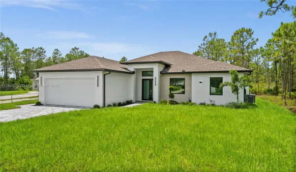 Prairie-style home with an attached garage,
roof with shingles, driveway, a front yard, and
stucco siding