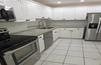 REMODELED KITCHEN WITH GREAT STANLESS STEEL APPLIANCES