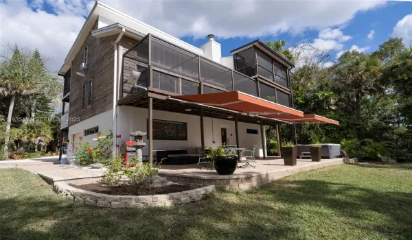 First floor entry from back patio with jacuzzi and sitting area area with river views.