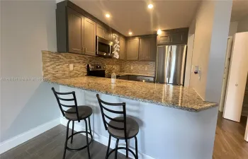 Open kitchen with stainless appliances
