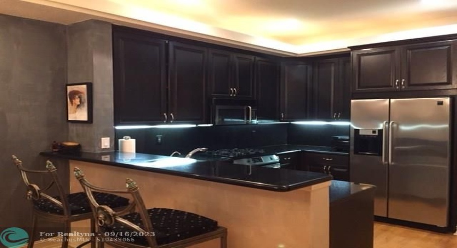 Custom kitchen with stainless steal appliances and gas range