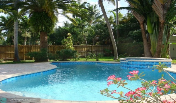Tropically landscaped, mature majestic palms and inviting heated pool and spa on a large private, fenced lot.