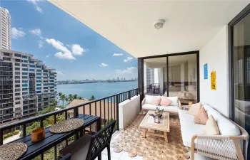 Relax on your private balcony with peaceful bay and skyline views