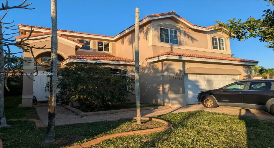 Single-family house featuring Mediterranean style architectureresidence perfect for family living, complete with an attached garage and traditional New tile roof.