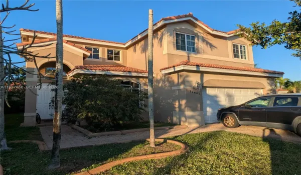 Single-family house featuring Mediterranean style architectureresidence perfect for family living, complete with an attached garage and traditional New tile roof.