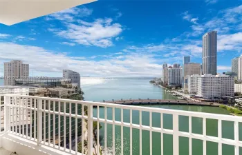 Balcony access from living room and main bedroom with direct water views