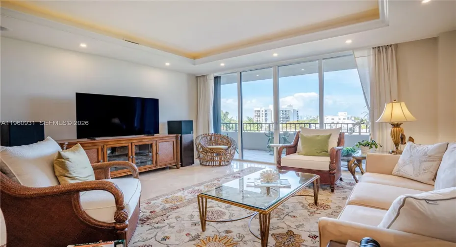 The Living room features floor-to-ceiling glass doors that allow natural light to flood the space.