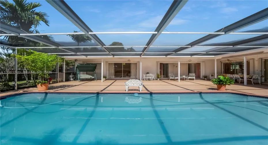 Gorgeous pool and huge patio with sliders all around providing access throughout the home and tons of natural light.