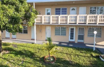 Well-maintained building exterior within the 55+ Ro-Mont South community, featuring clean lines and landscaped common areas.